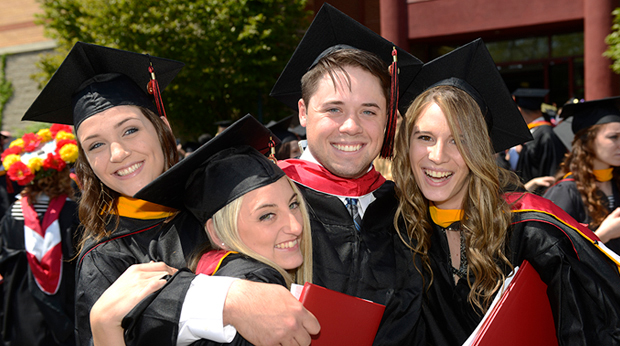 Graduates hugging and celebrating together